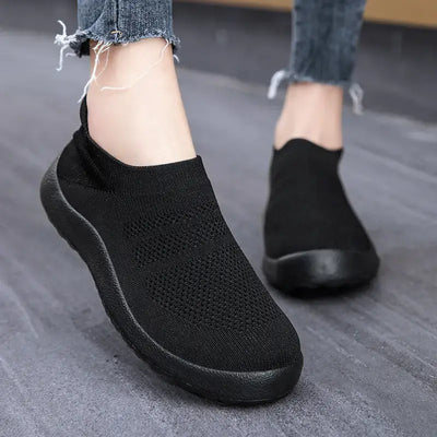 Casual Flyknit Slip-On Sneakers in black, showcasing breathable design and lightweight comfort, ideal for everyday wear.
