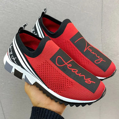 Red breathable woven sneakers with black accents, stylish and comfortable for casual wear.