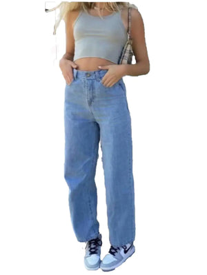Woman wearing high-rise wide-leg jeans with a cropped top and sneakers, showcasing casual, stylish fashion.