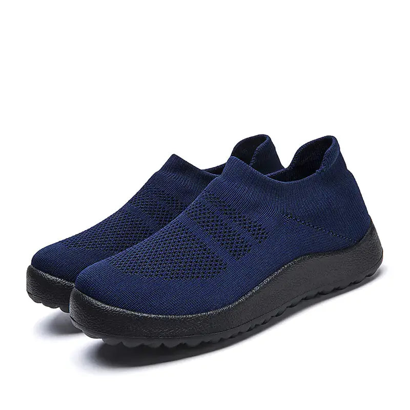 Casual Flyknit Slip-On Sneakers in navy blue, featuring a lightweight and breathable design for all-day comfort.