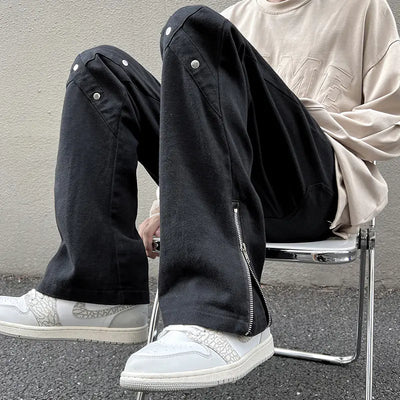 Men's Zipper Jeans by TideGangster showcased on a model sitting, featuring trendy zipper accents for urban style.