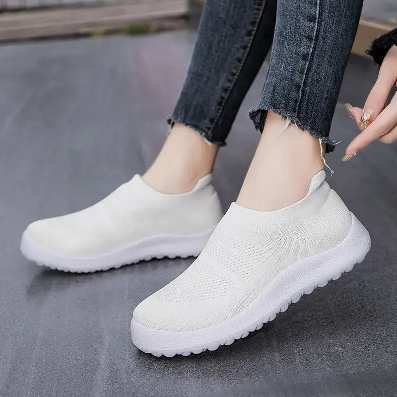 Casual Flyknit Slip-On Sneakers in white, featuring a breathable upper and flexible sole, ideal for all-day comfort.