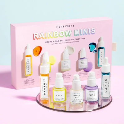 HERBIVORE Rainbow Minis Set featuring colorful skincare serums on a display; includes mini best sellers for glowing skin.