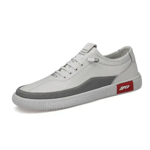 Stylish leather casual sneakers in white and gray with red accents, perfect for versatile everyday wear.